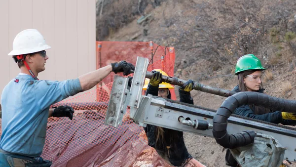 A group of people in hard hats and hard hats working on a construction site.