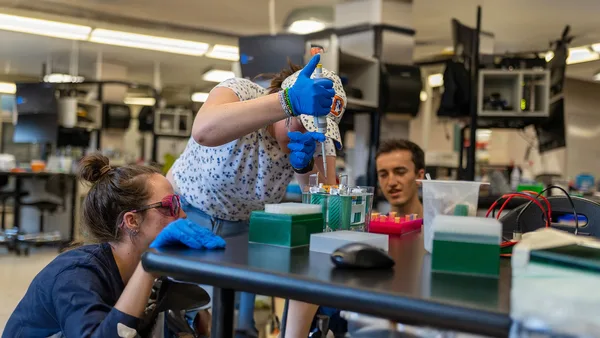 A group of people working in a lab.