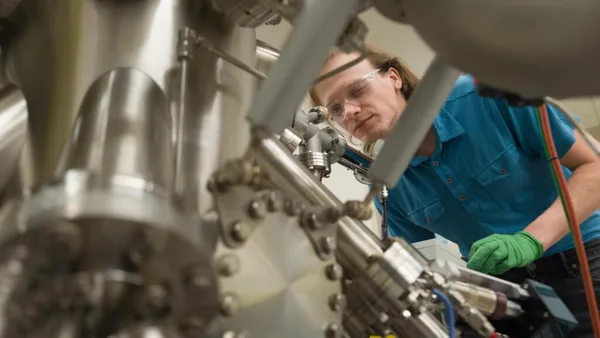 Quantum engineer student working with molecular beam epitaxy system.