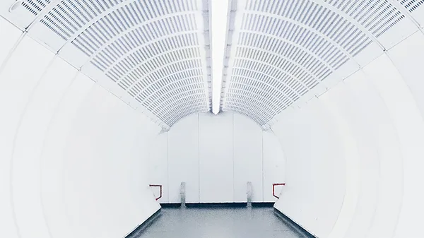 A long white tunnel with a light at the end.