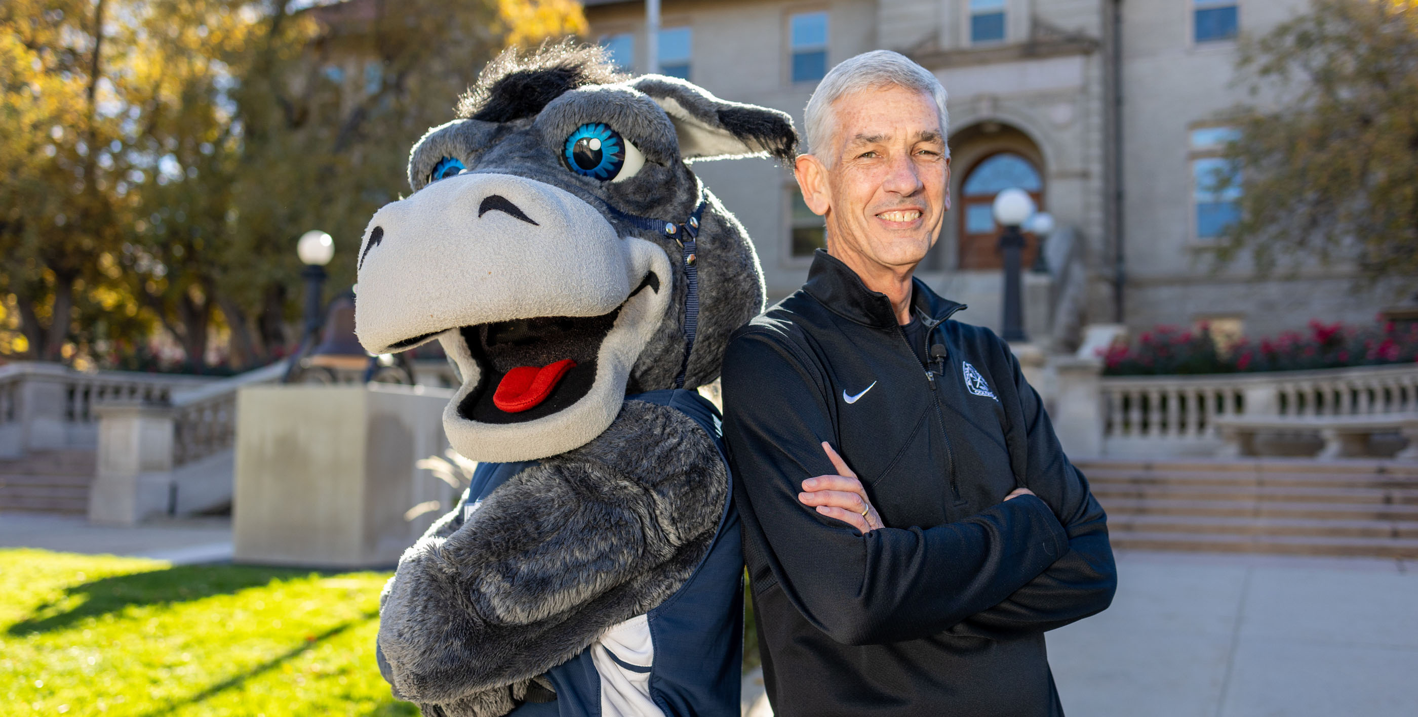 President Johnson and Blaster posing in front of Guggenheim Hall