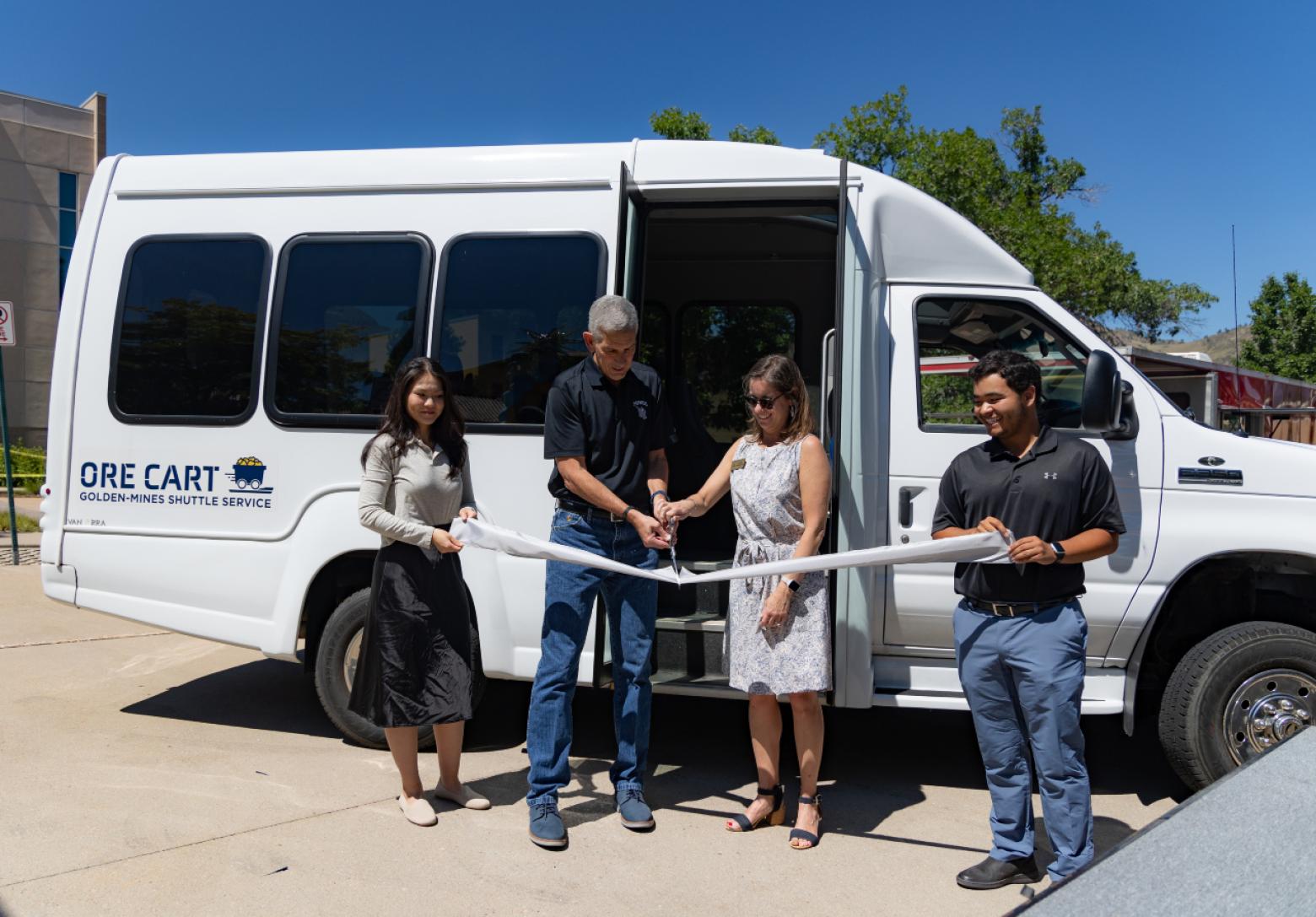 President Paul C. Johnson and Golden Mayor Laura Weinberg cut the ribbon to introduce the new Ore Cart Shuttle routes, free transportation for Mines students.