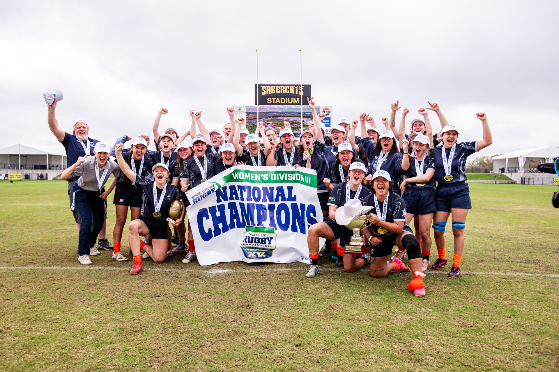 Mines Womens Club Rugby Team poses with championship banner