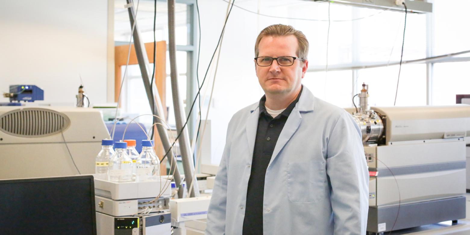 Christopher Higgins posing for a photo in his lab