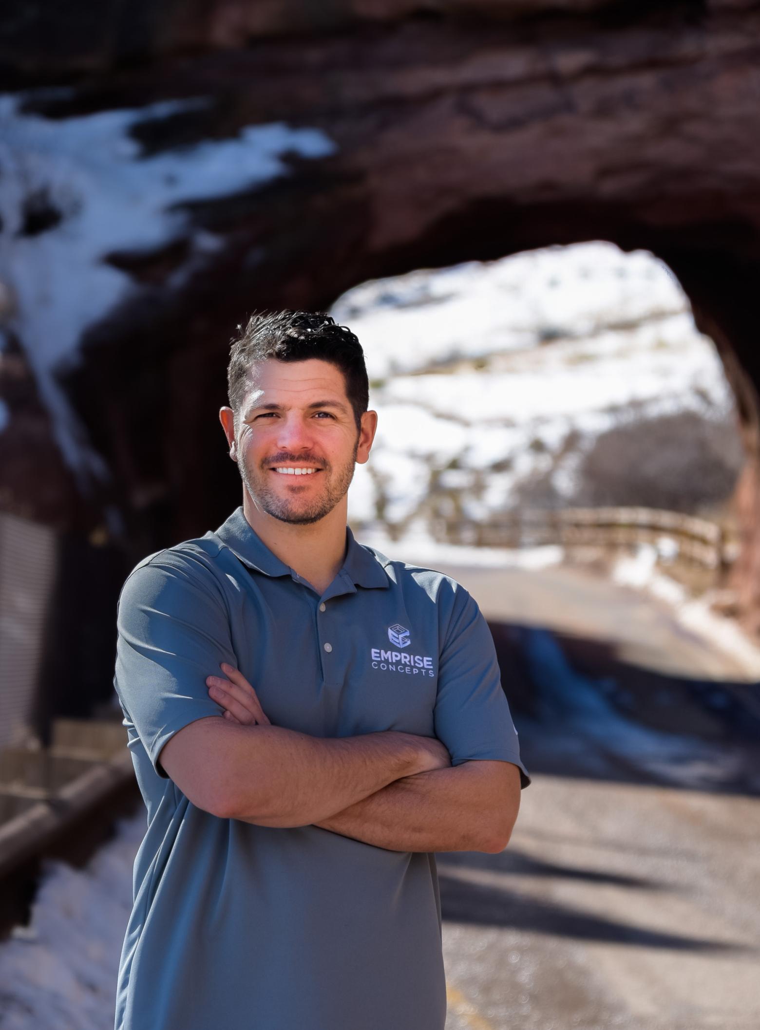 Jacob Grasmick, Mines alum MS ’13, PhD ‘19, poses in front of a highway tunnel.