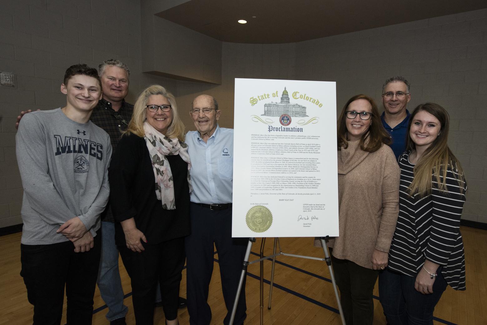 Marv Kay and his family pose with the official Marv Kay Day proclamation in 2019.