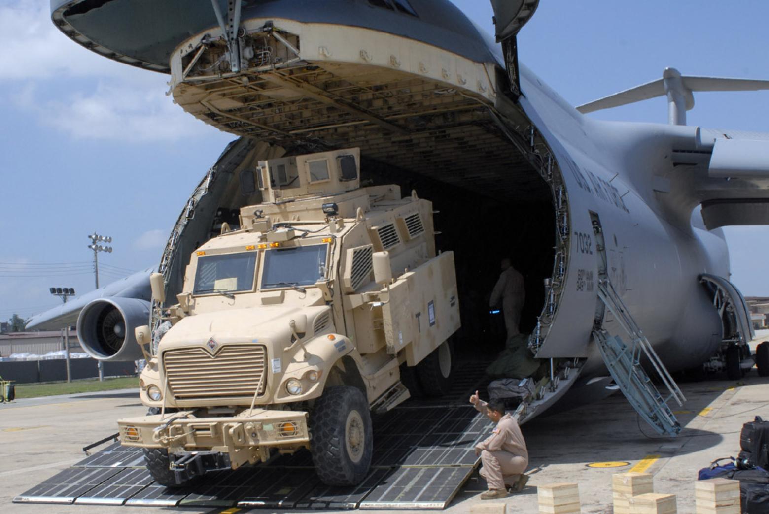 Mine Resistant Ambush Protected vehicle rolls off a cargo plane