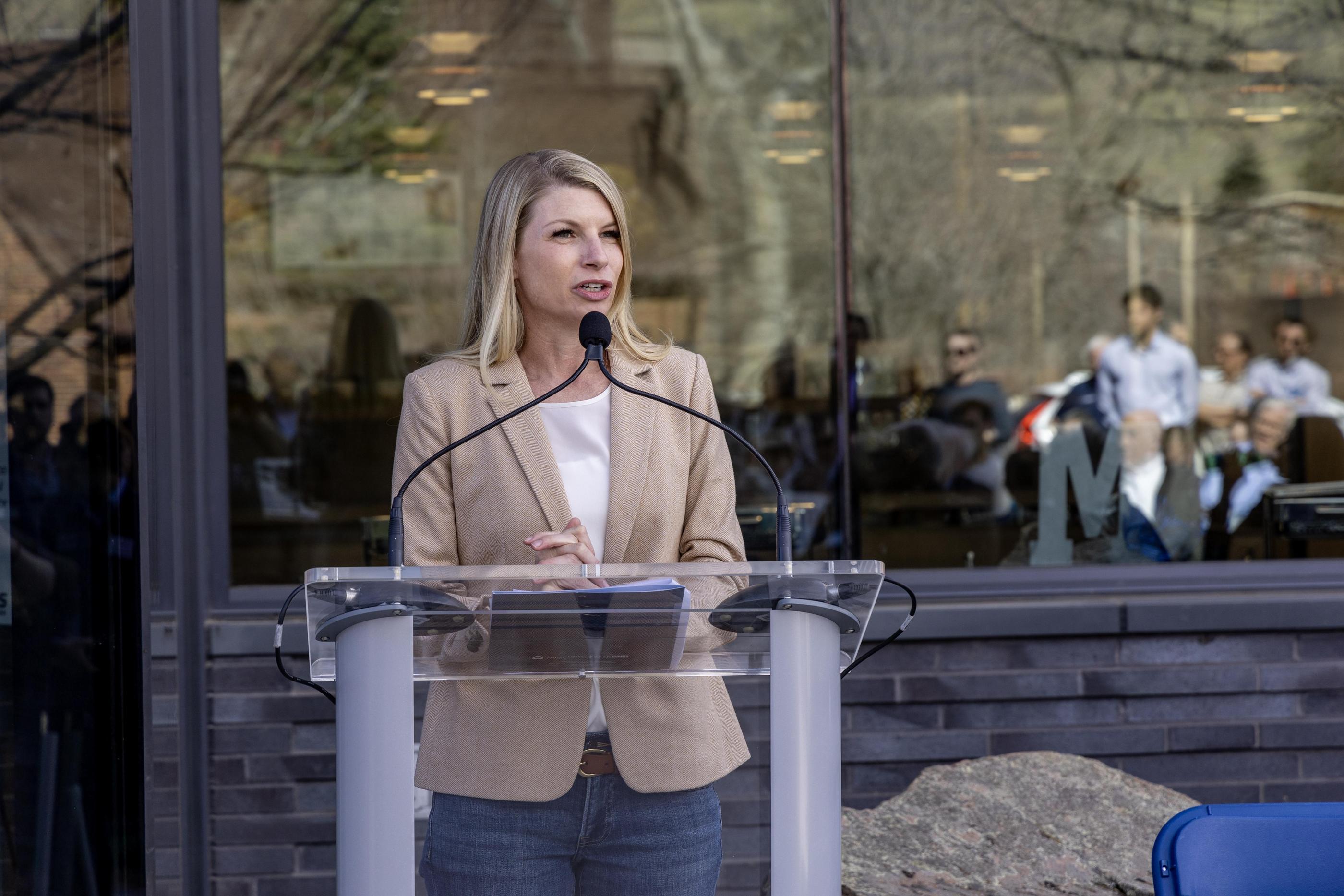 Rep. Brittany Pettersen speaks at a podium