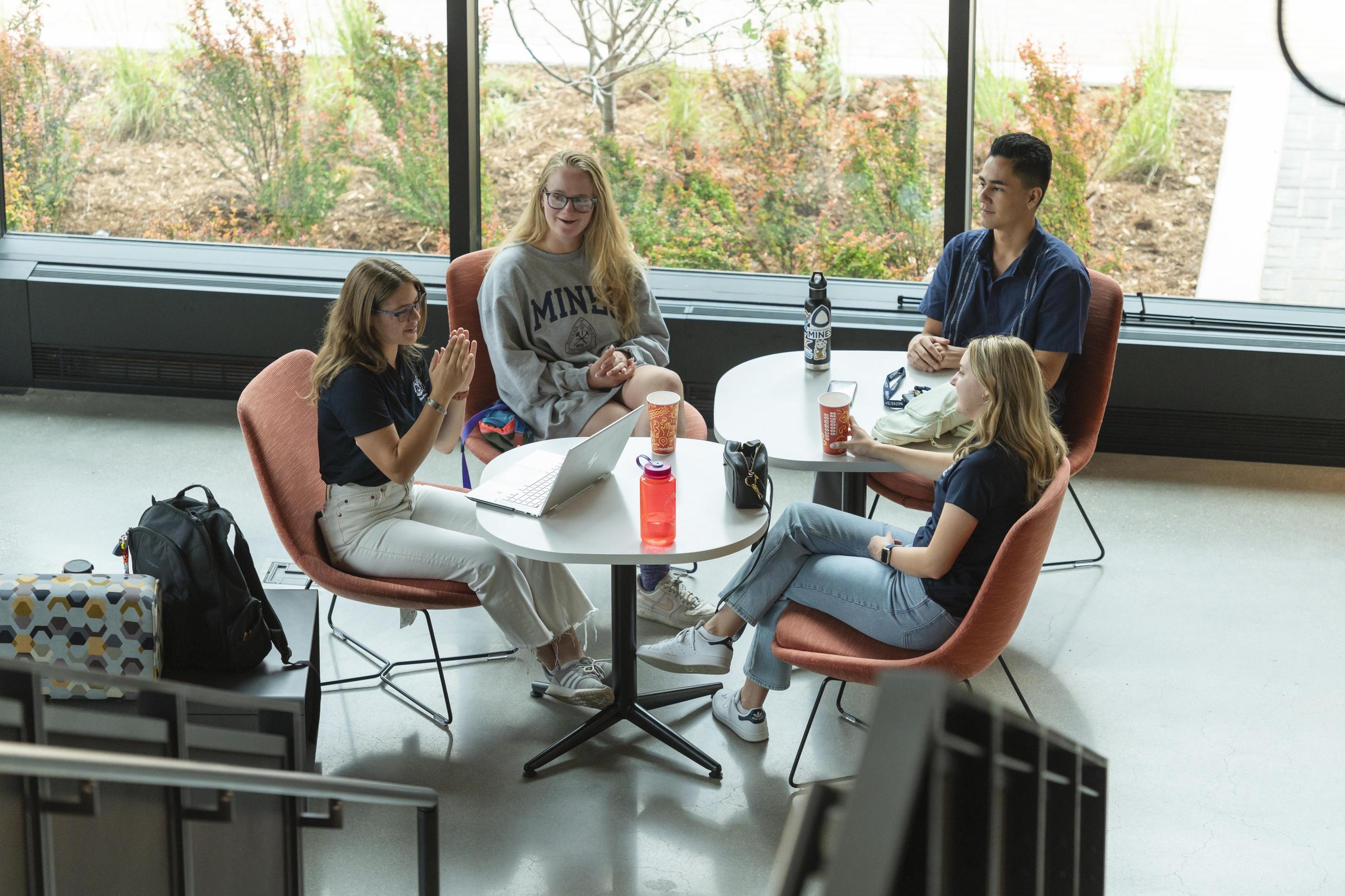 A group of students sits around a table in the Beck Venture Center