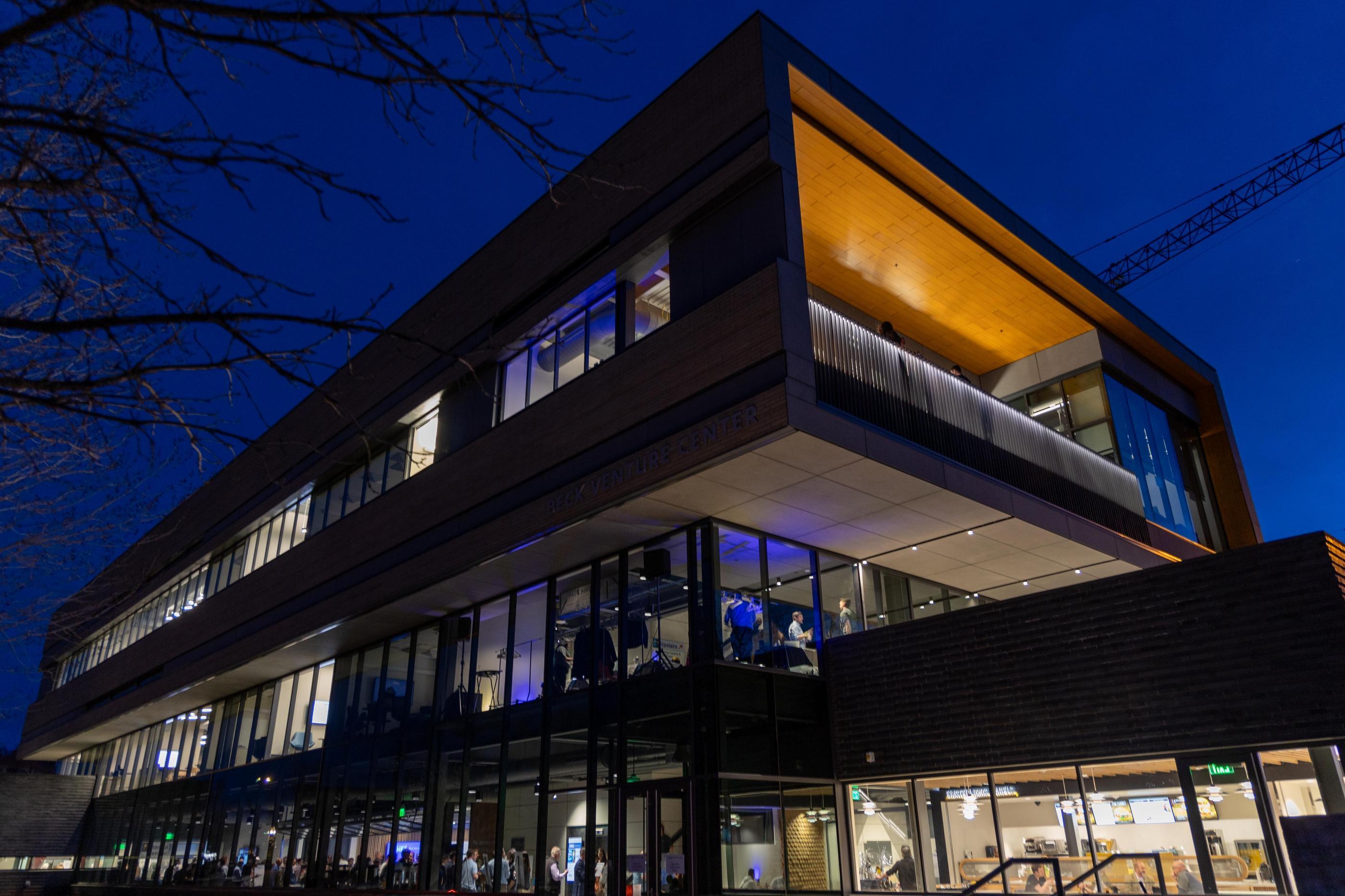 Exterior view of Beck Venture Center at night with windows illuminated