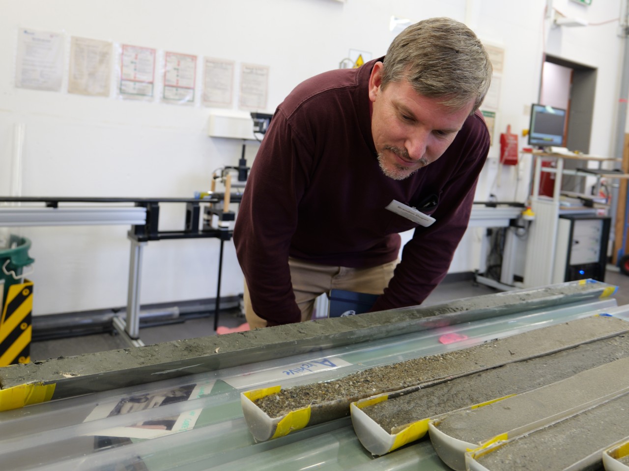 Brandon Dugan examines a core removed from under the ocean