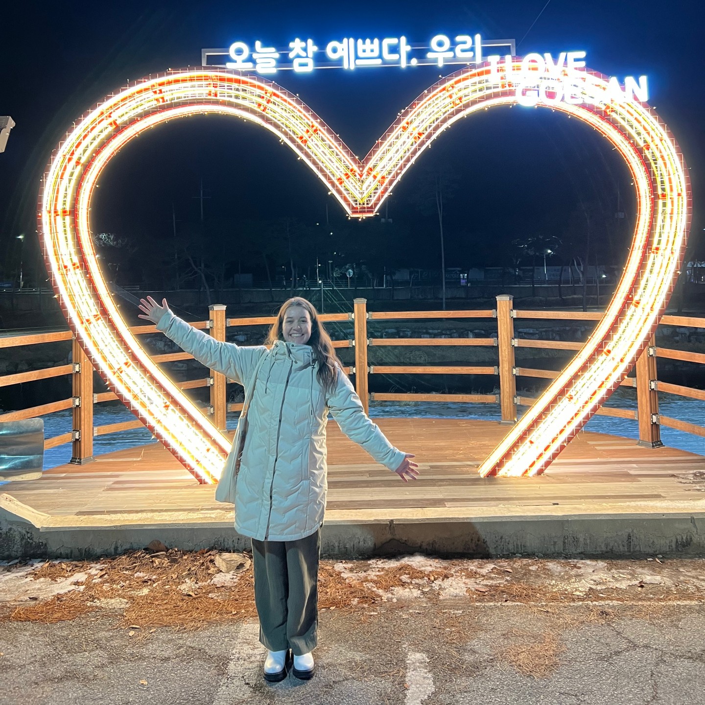 Camila Garcia-Ferreyra stands in front of illuminated heart statue in Korea