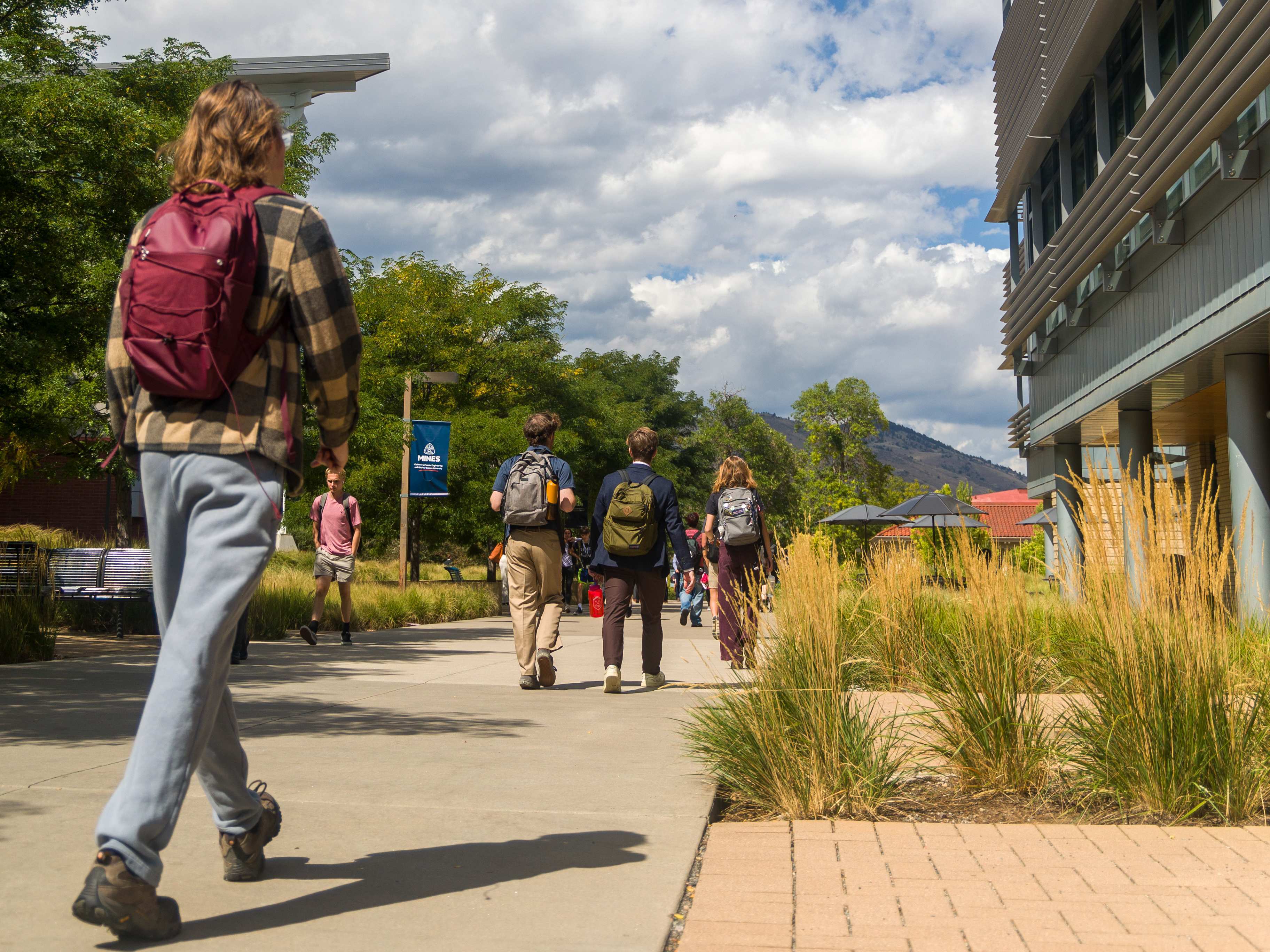 students walk away down a pedestrian path
