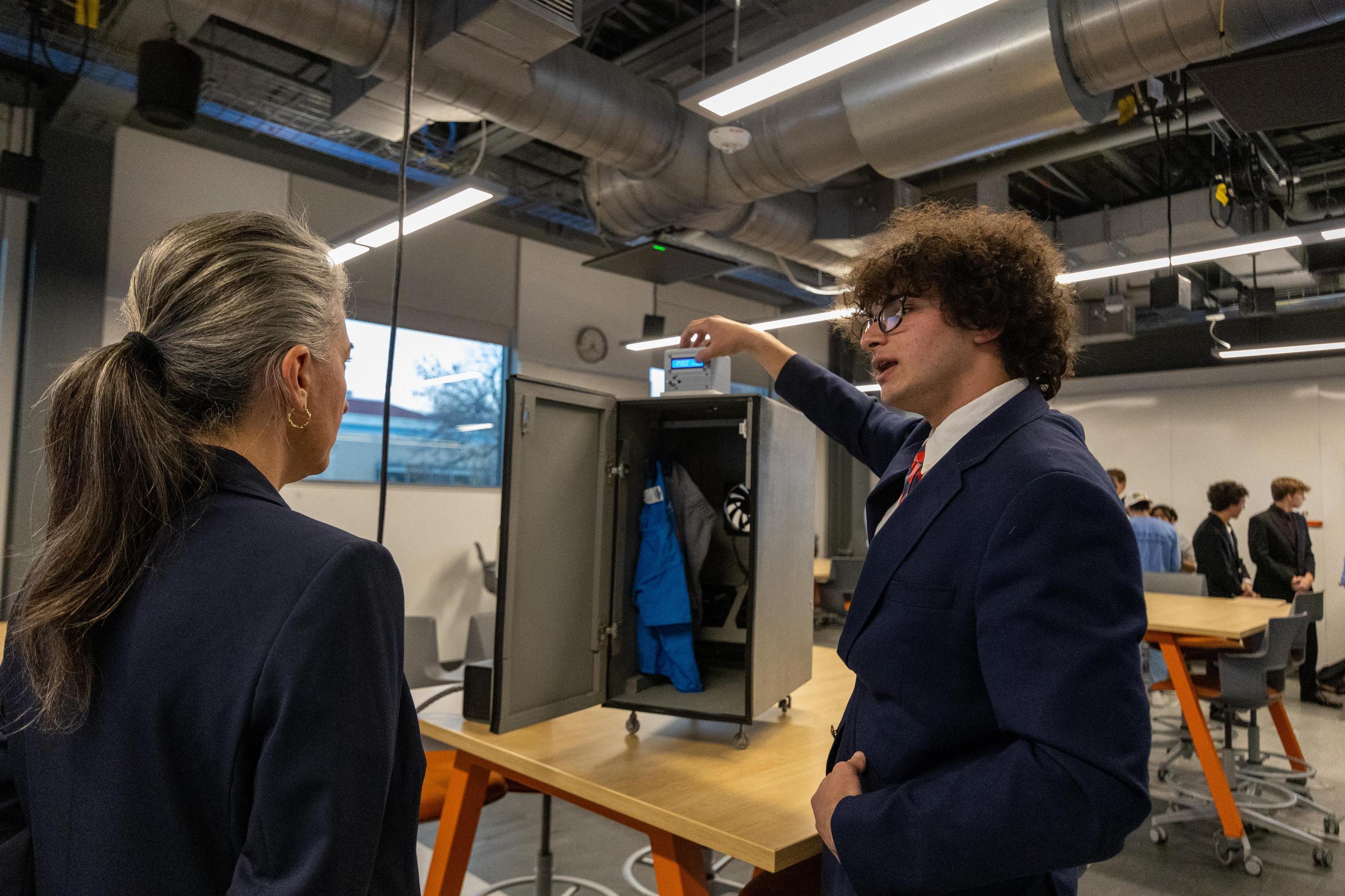 Students shows off prototype to judge during Cornerstone Design Final Competition