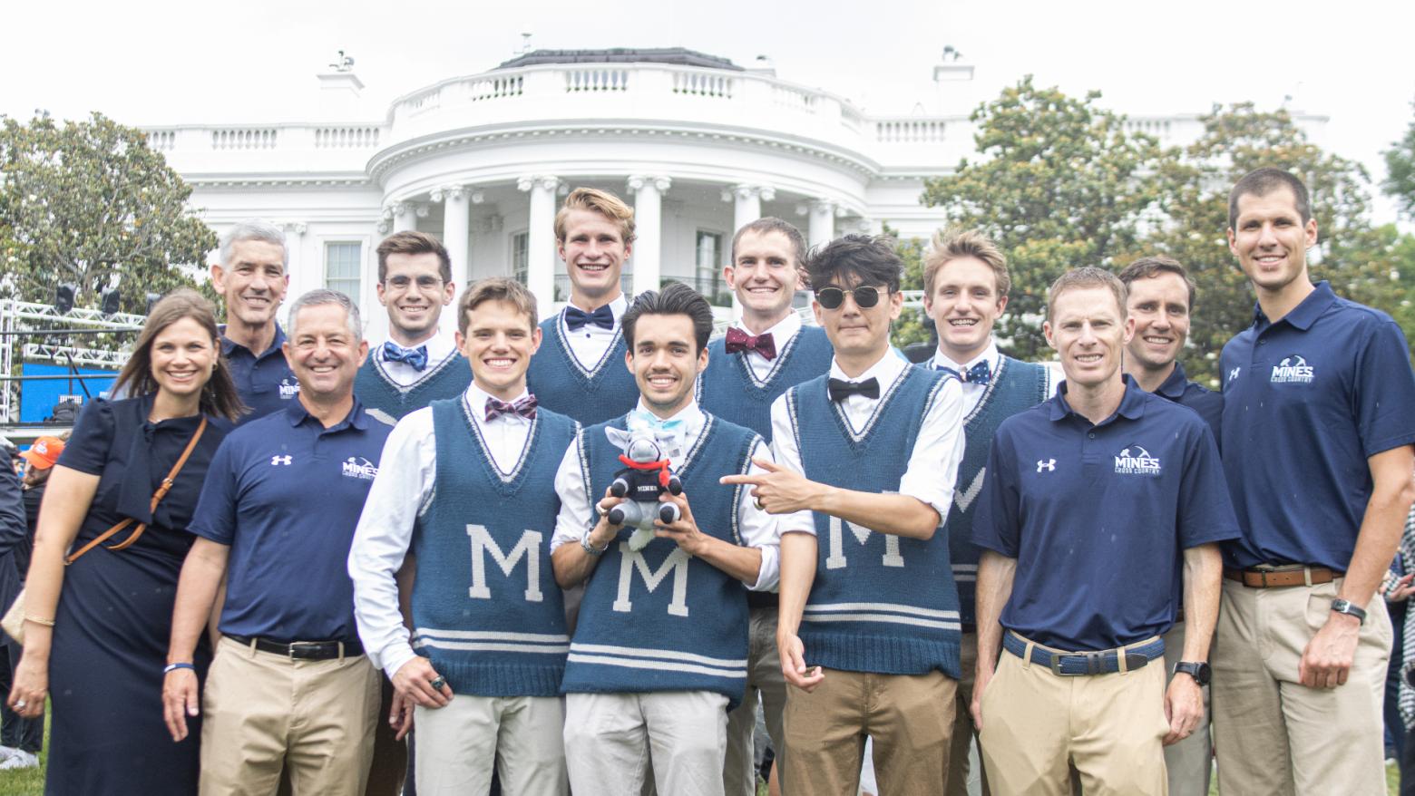 Mines Cross Country Team poses in front of the White House