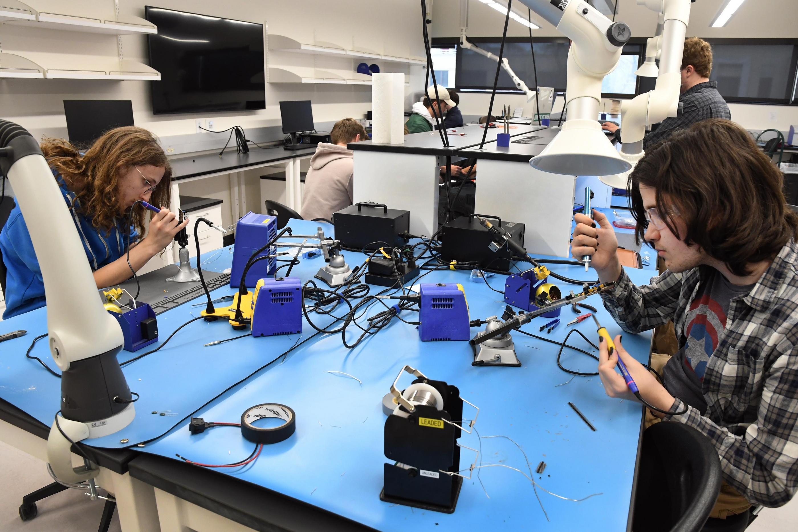 Students work on electrical projects in the Electronics Discover Center