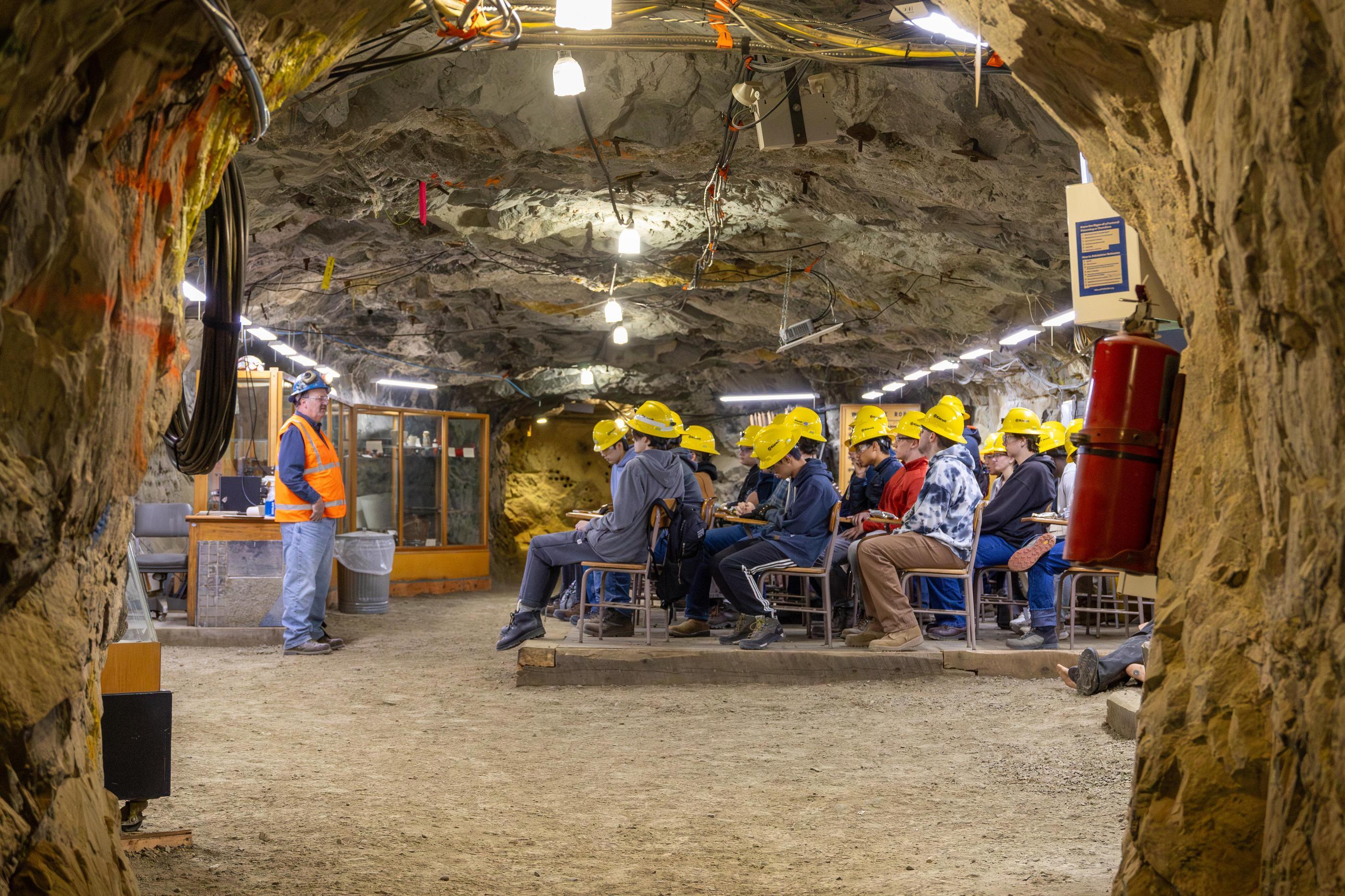 Colorado School of Mines students in hard hats sit at desks for a class inside the Edgar Experimental Mine
