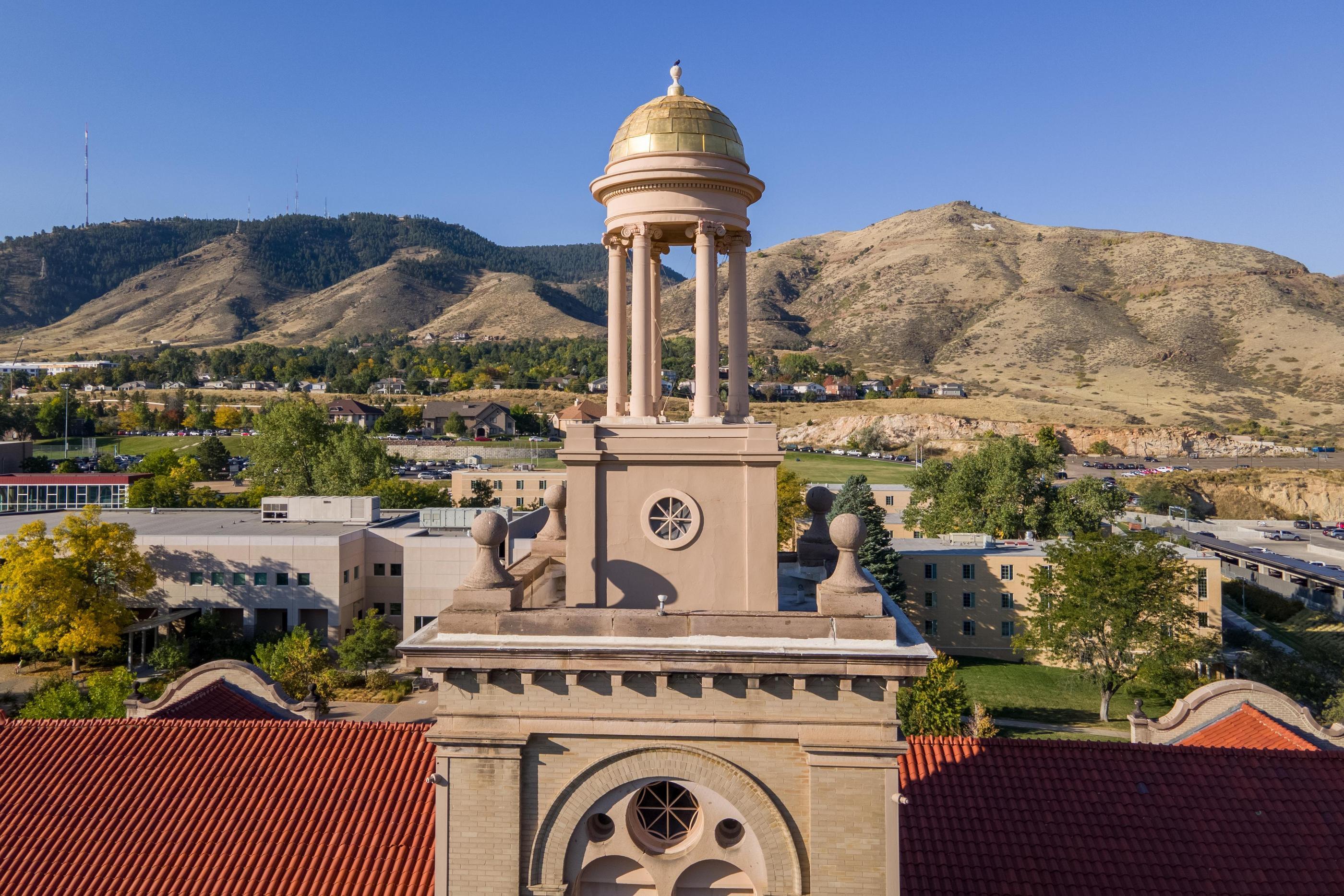 The tower and gold dome of Guggenheim Hall with Mount Zion in the background