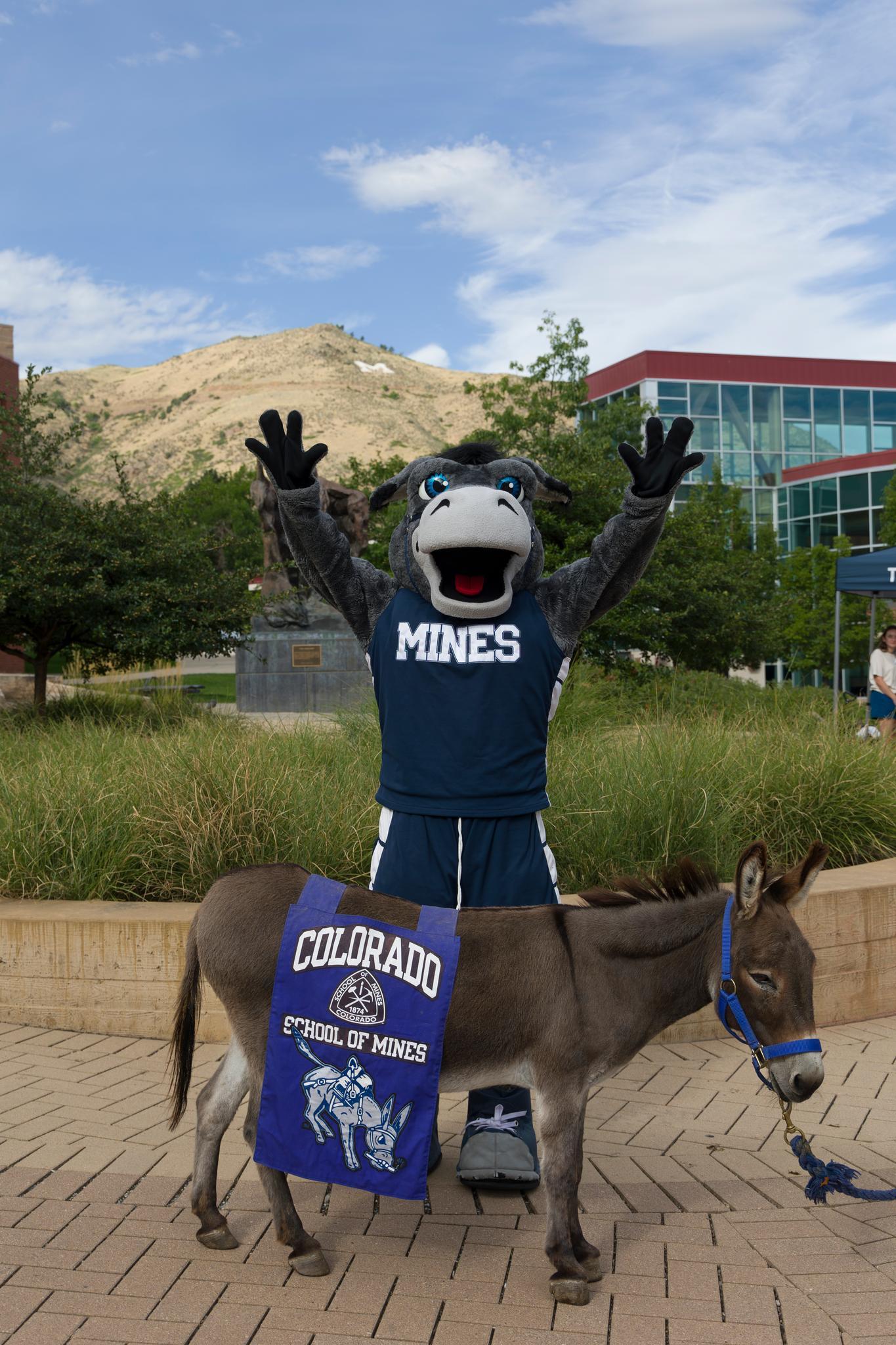 Blaster the mascot poses with Blaster the burro on Maple Plaza