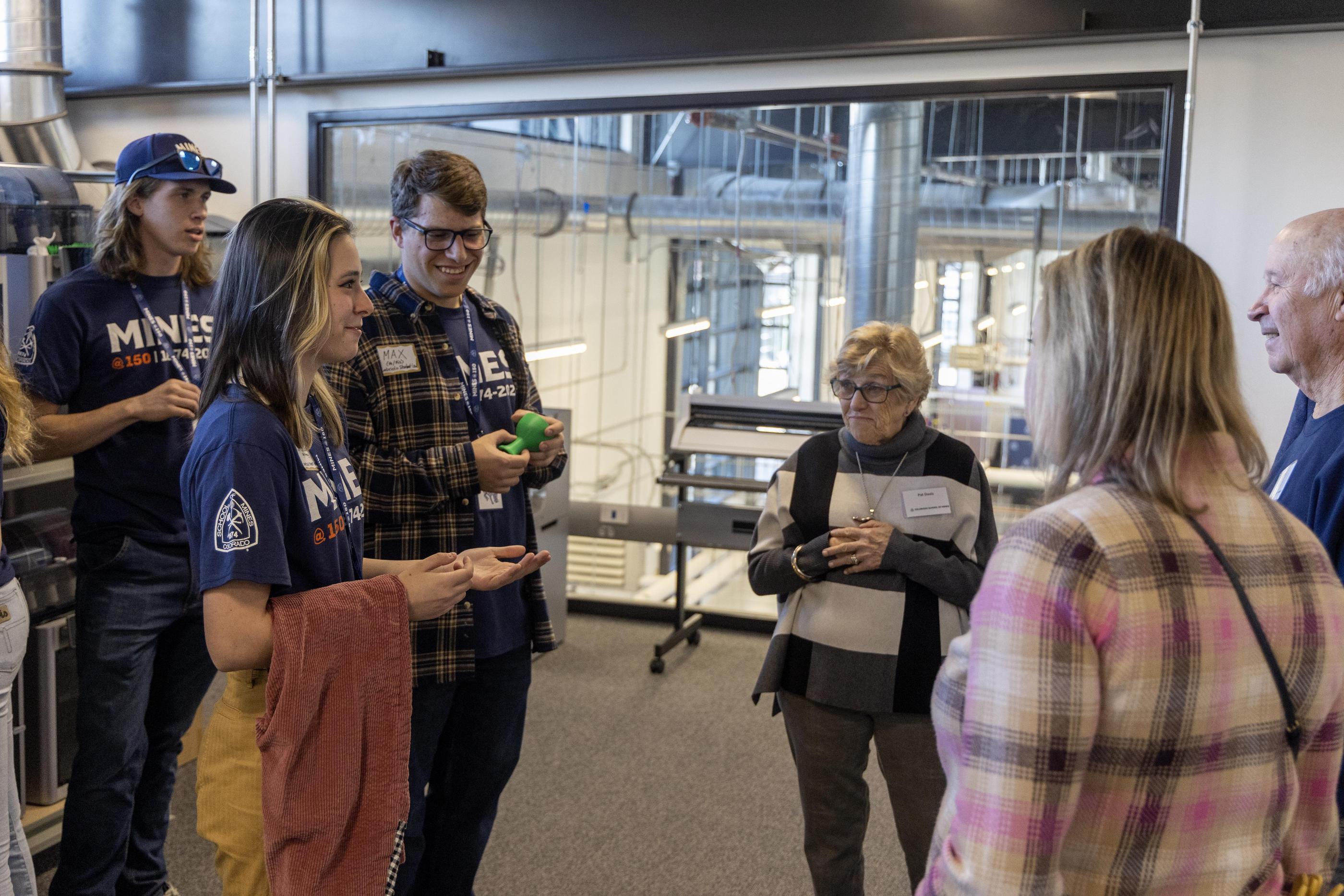 A group of alumni and students tour a lab inside Labriola