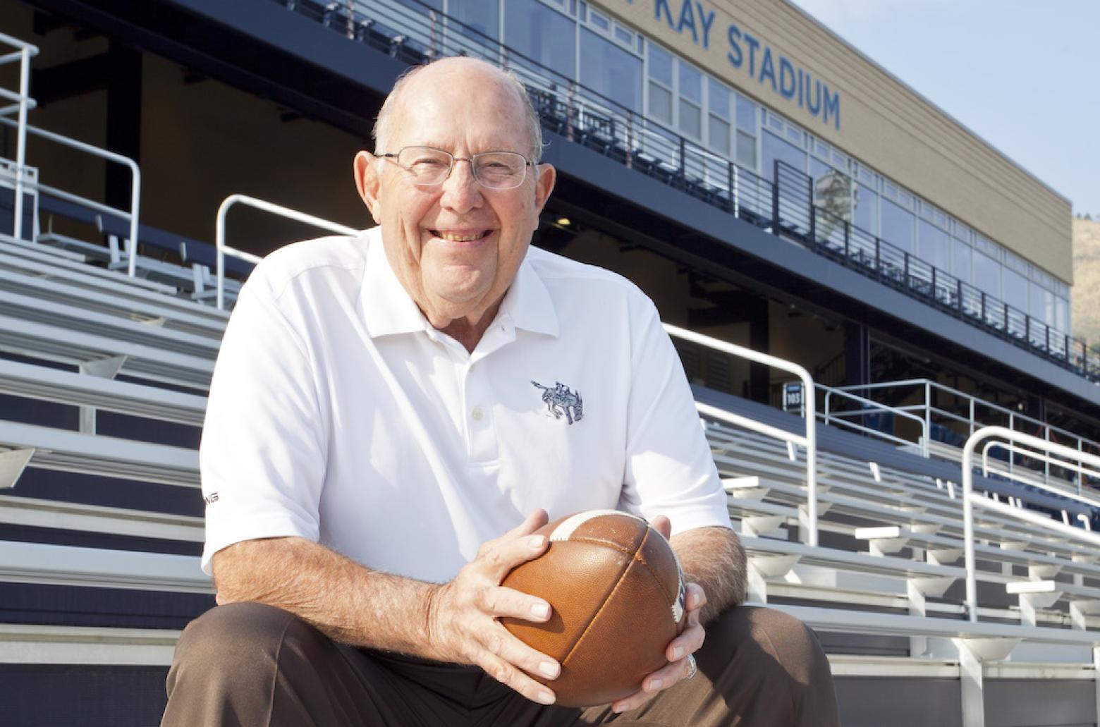 Marv Kay sitting in the bleachers of Marv Kay stadium