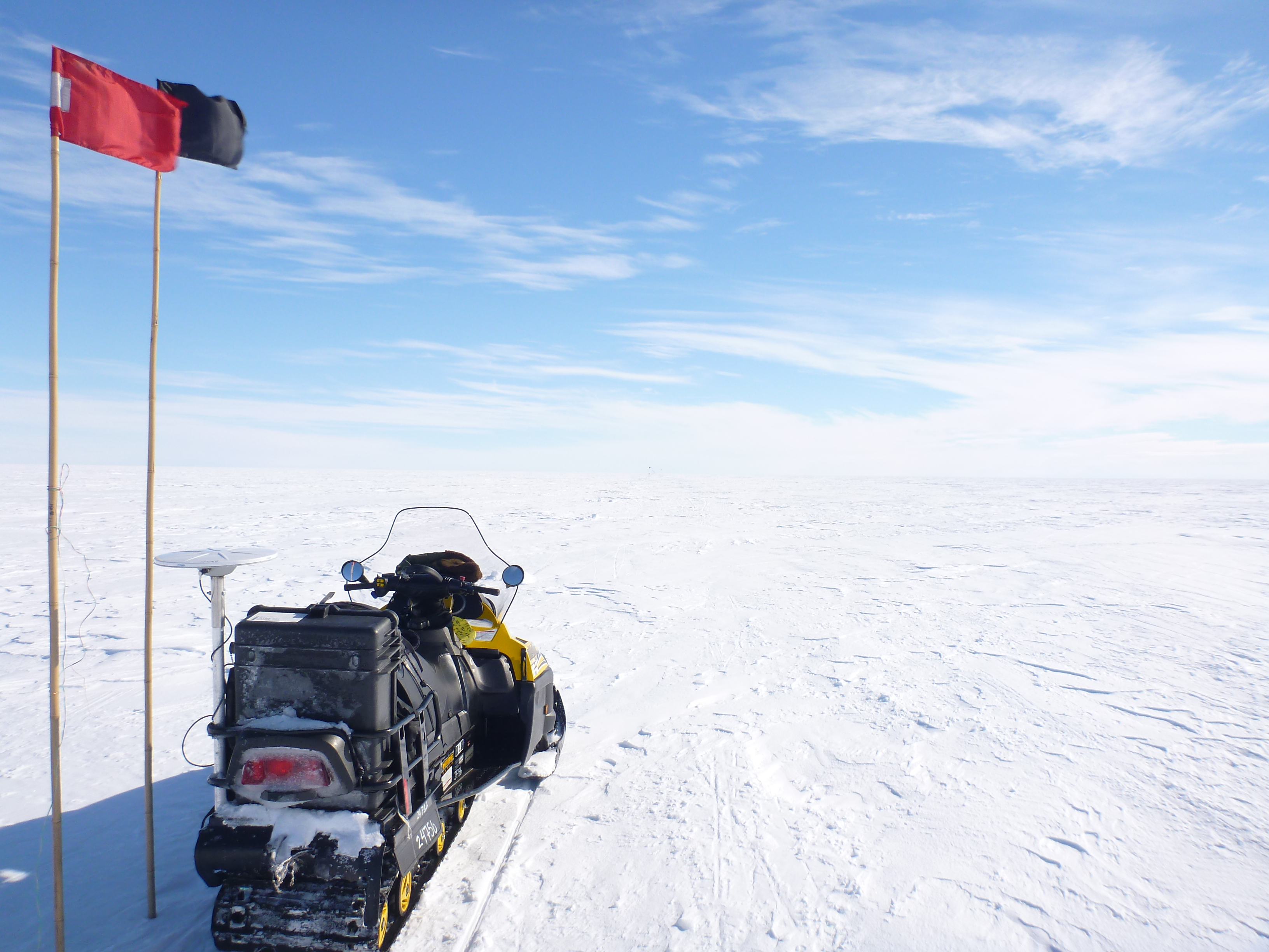 A snowmobile sits on Antarctic ice during geophysical research