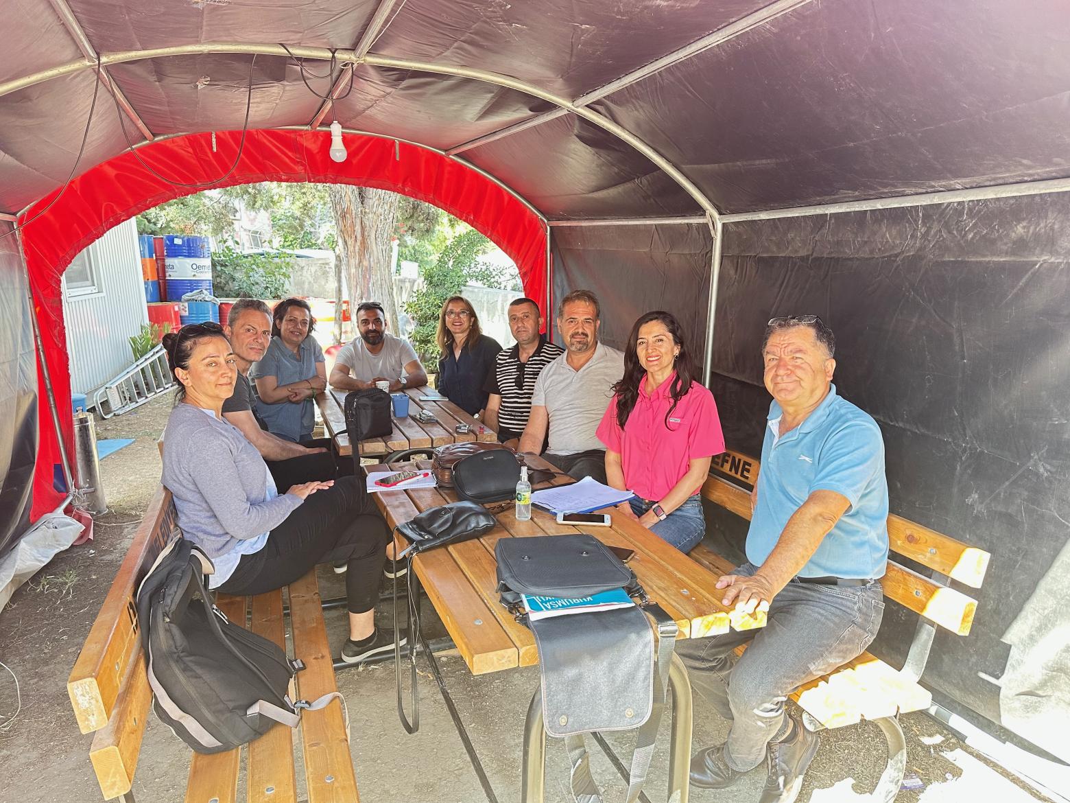 Professor Duzgun makes plans for rebuilding Antakya Turkiye after the earthquake with a team in a temporary project site tent.