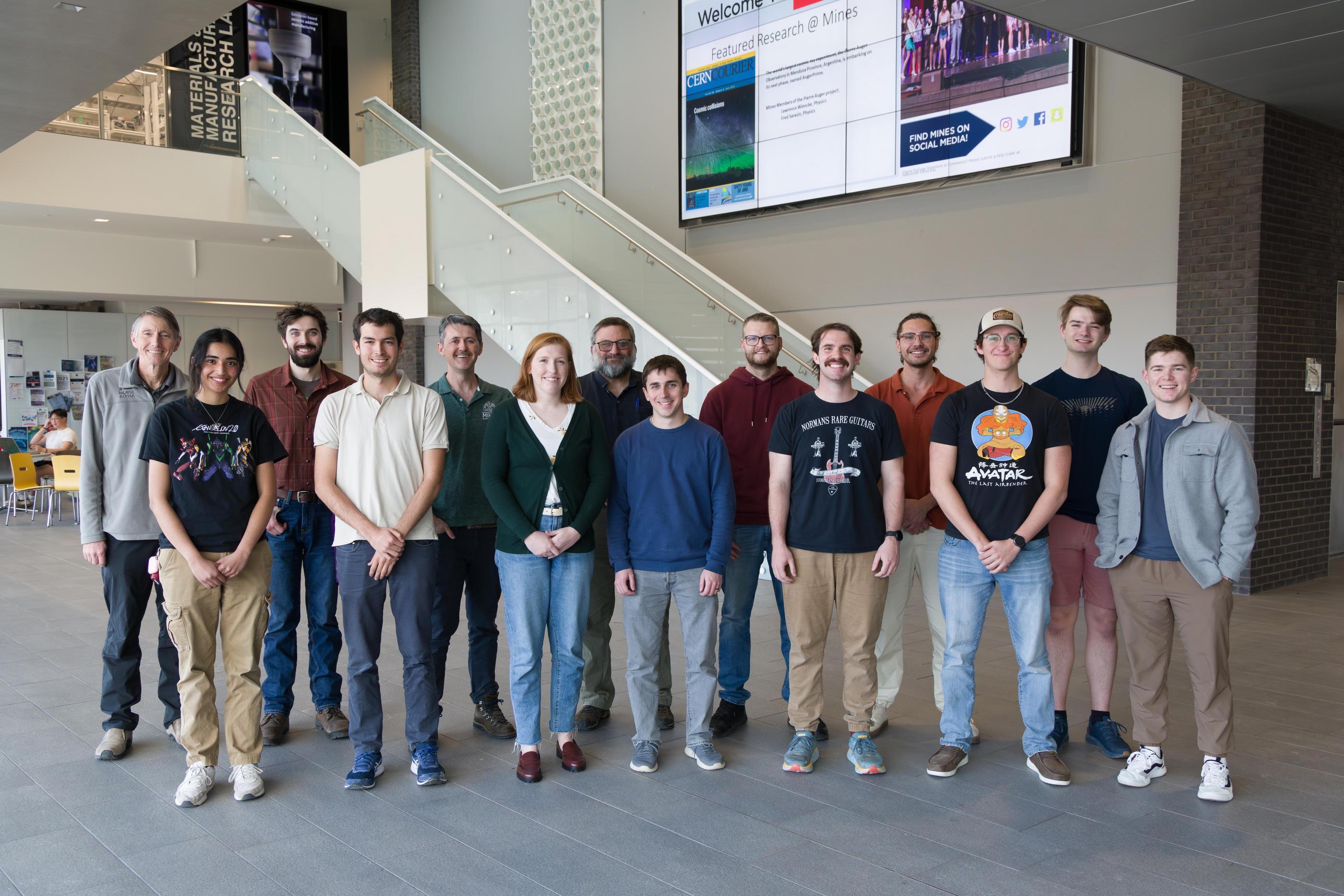 A group of Mines students and faculty members pose for photo in CoorsTek Atrium