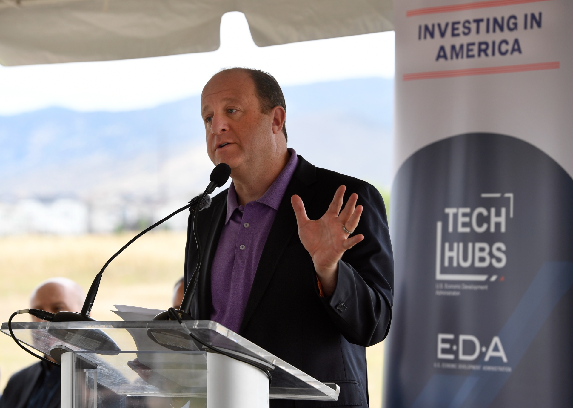 Gov. Jared Polis speaks at a podium