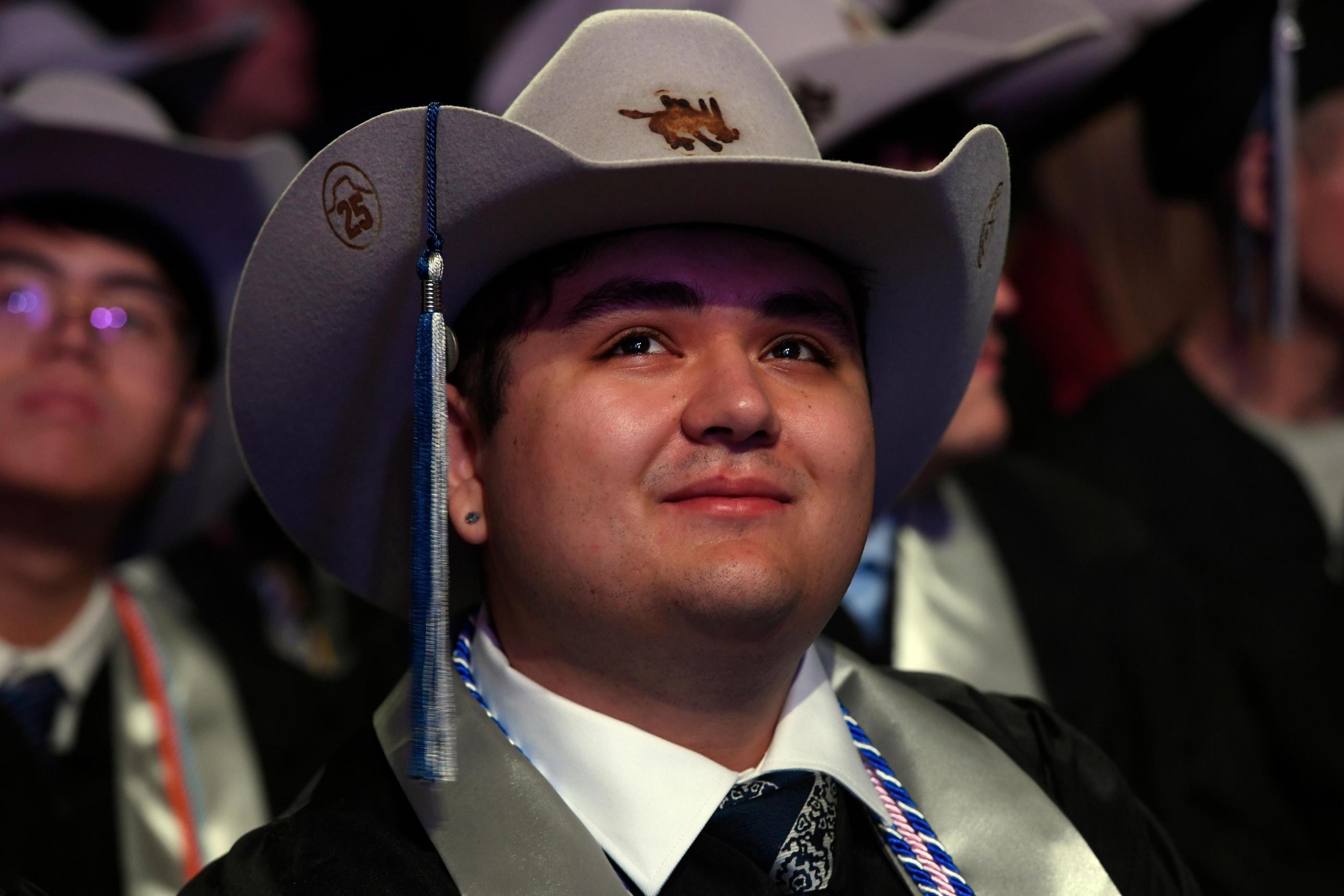 Student in the crowd at Fall 2025 Midyear Commencement for undergraduate studens