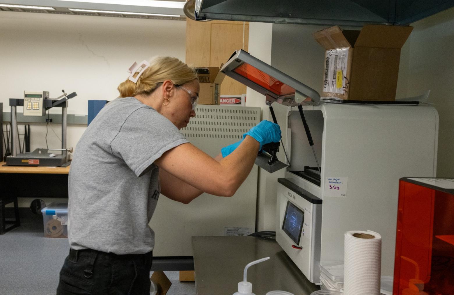 Lakewood High School teacher Ashley Pederson works with ceramic resin in an additive manufacturing lab on the Mines campus.