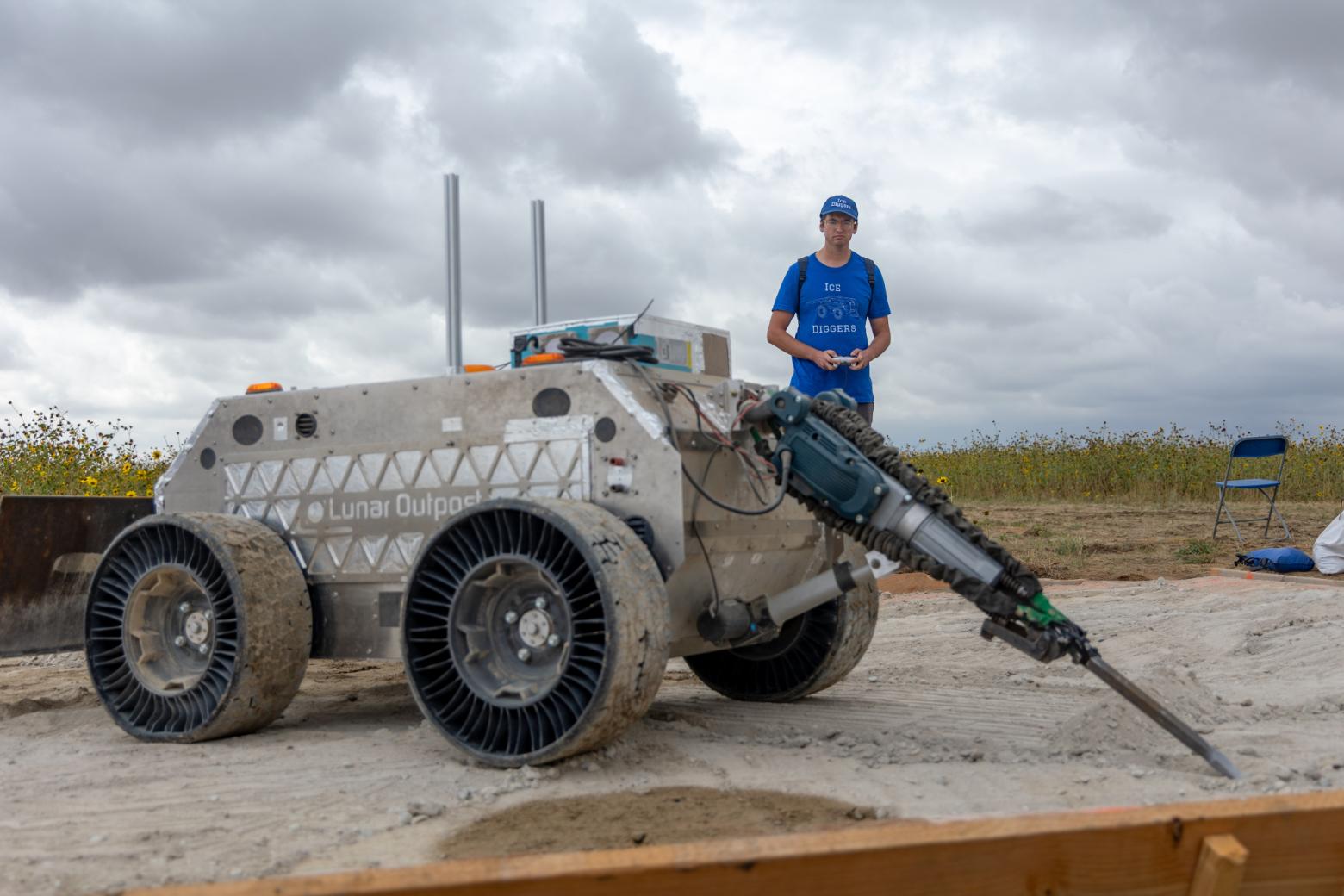 Mechanical Engineering graduate student Brendan Kearney operates the impact hammer on the Outpost Digging System on the third day of durability testing at the Colorado Air and Space Port.