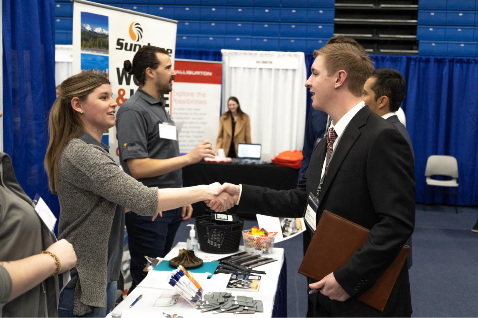 Chemical engineering senior Levi Collins shakes hands with a recruiter