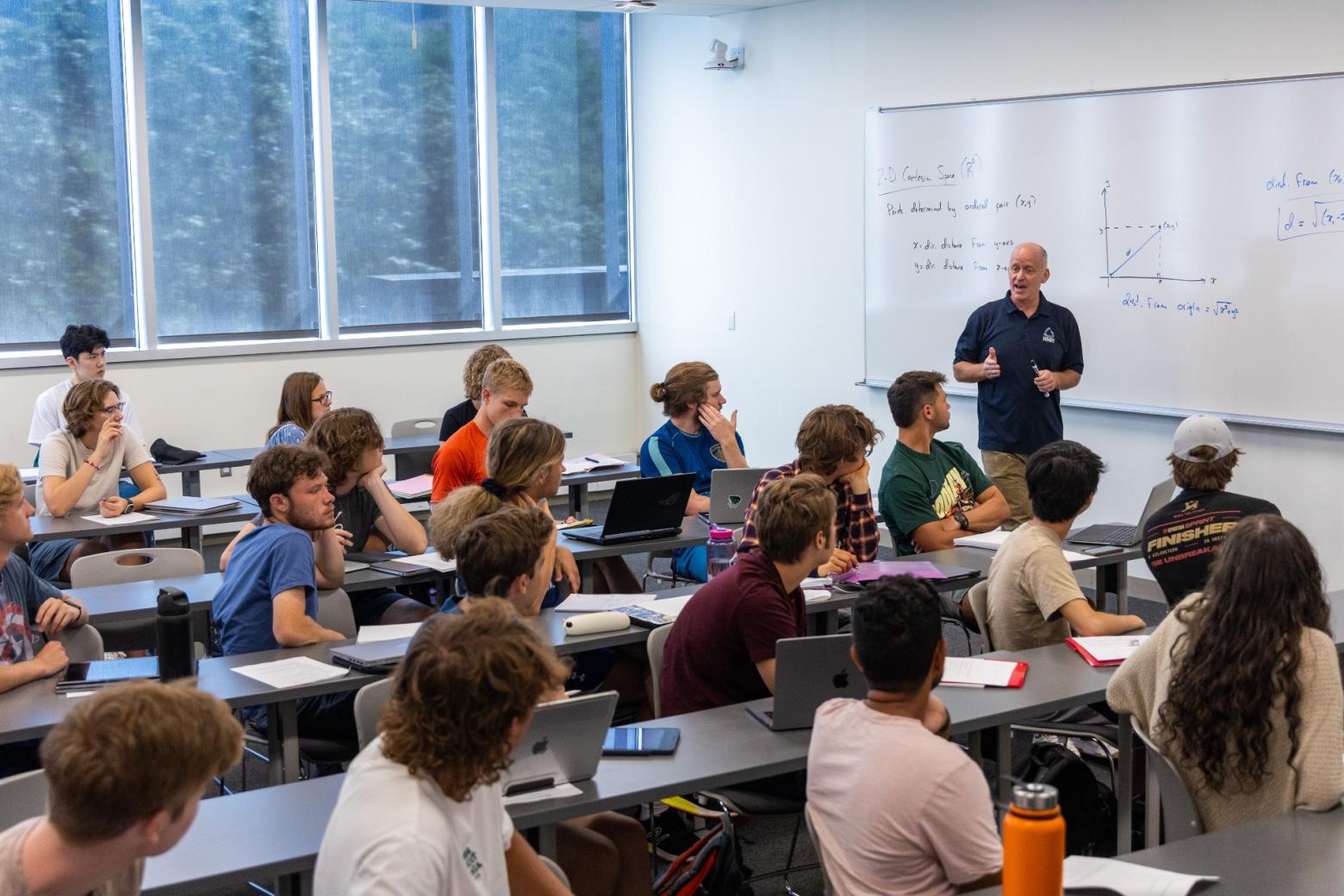Mines students sit in a classroom learning Calculus for Scientists and Engineers, taught by Gus Grievel.