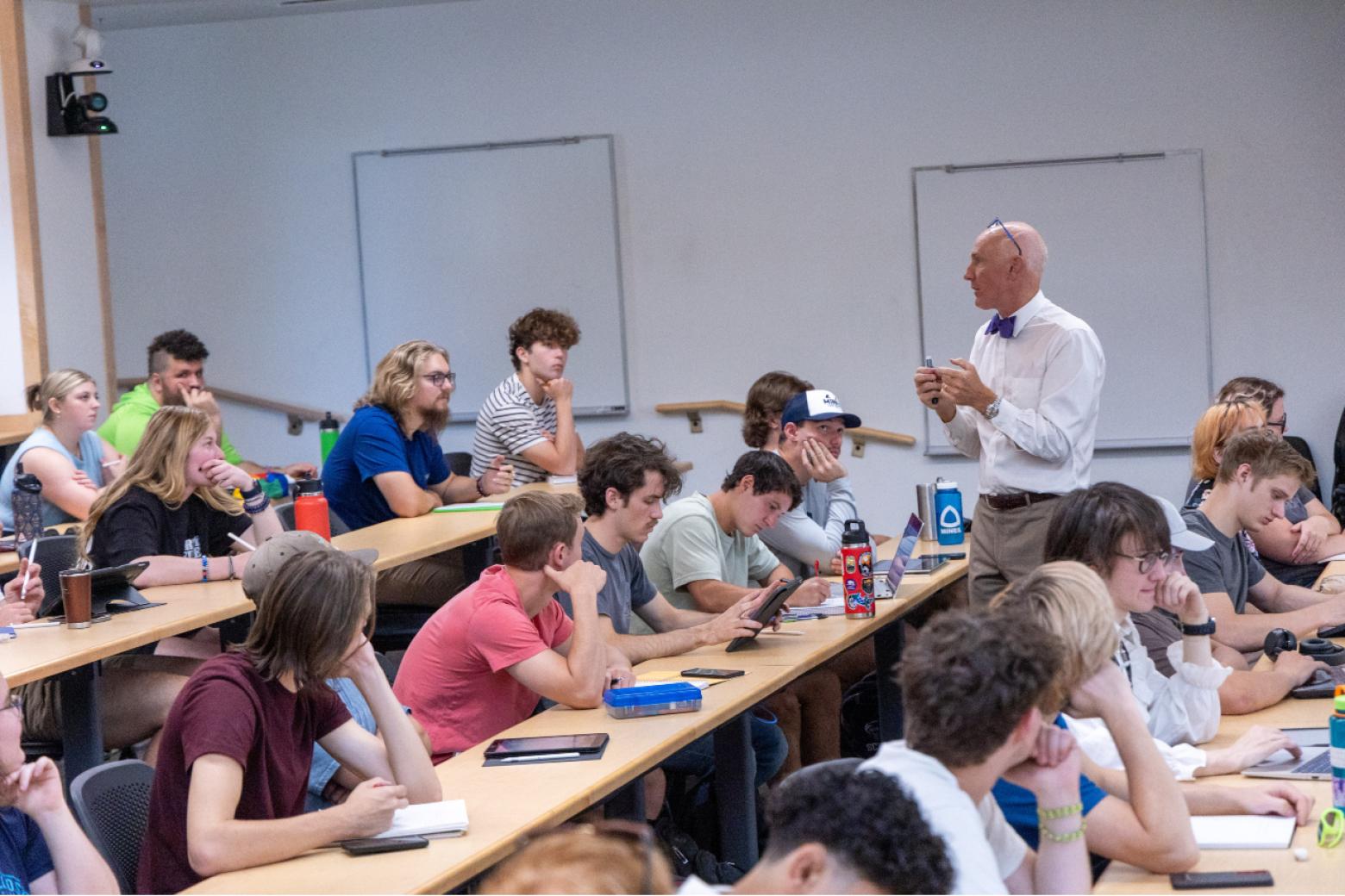 Mines students sit at their classroom desks listening to Chris Coulston, teaching professor of electrical engineering.