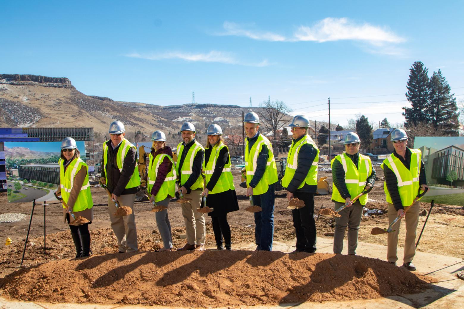 Mines officials celebrate the start of construction by breaking ground