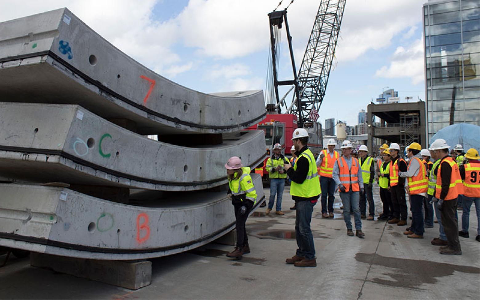 Mines Construction Engineering and Structural Engineering students and faculty stand among concrete slabs and cranes.