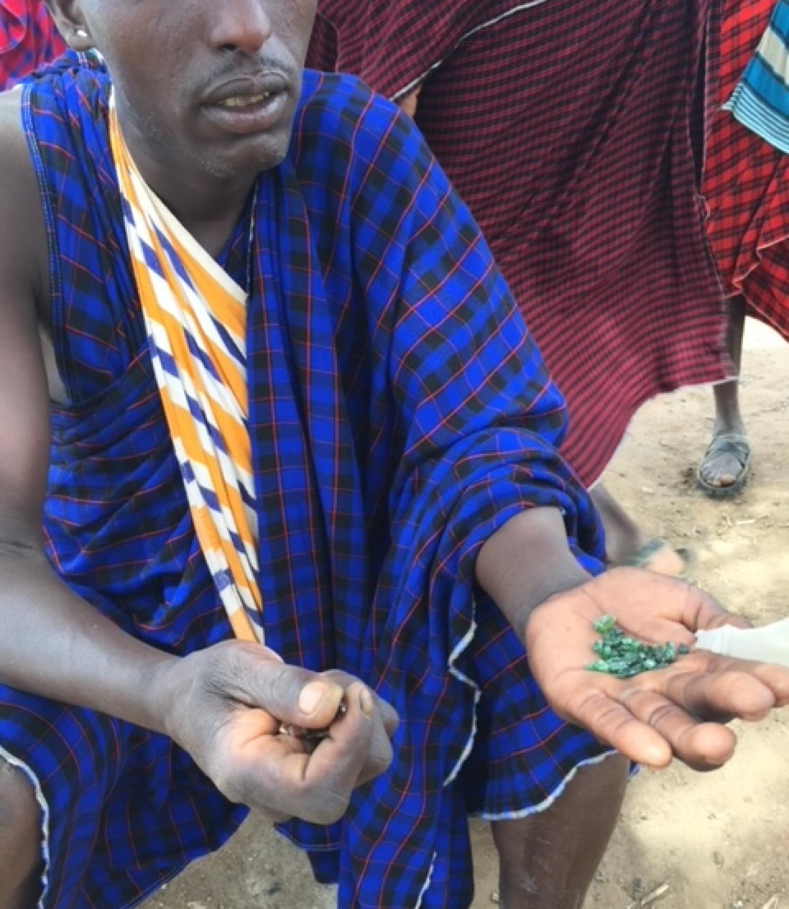 A gemstone trader in Tanzania shows the colored stones he plans to sell
