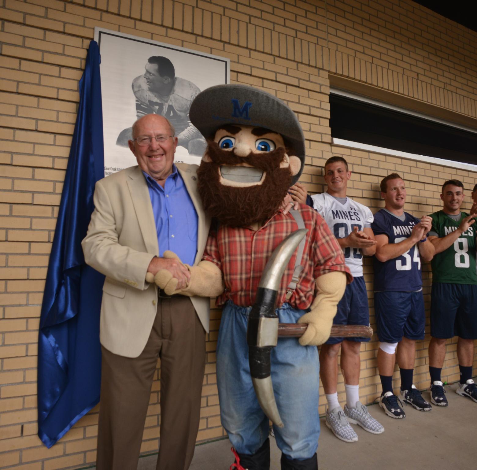 Marv Kay posing for a photo with Marvin the Miner