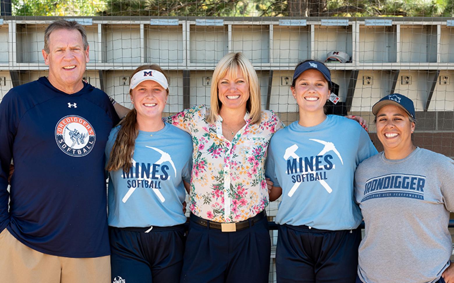 Mines Softball infielders Hannah Roberts and Sidney Wilson pose for a photo with alum Kerry Siggins ’01, Head Coach Mike Coutts and Assistant Coach Barb Duran.