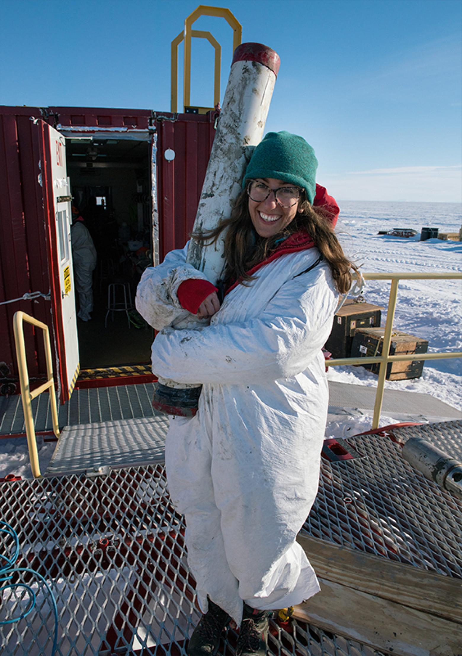 Ryan Venturelli holds the longest sediment core retrieved from a subglacial lake