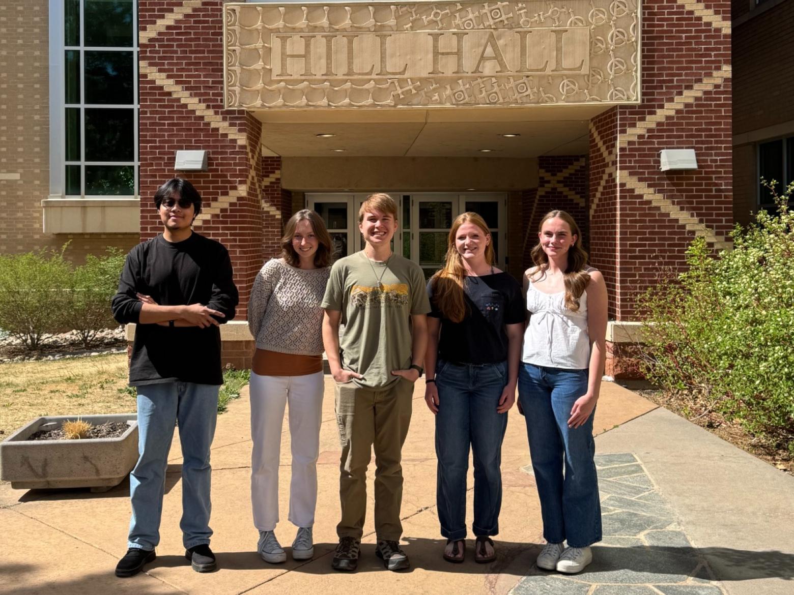 group shot of five Mines students in front of Hill Hall
