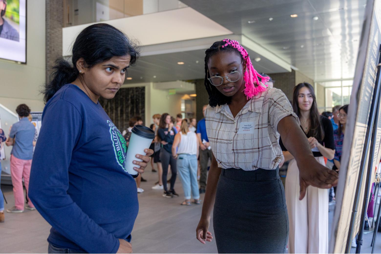 Praise Olusoji, a Quantitative Biosciences and Engineering major, discusses her research during the event.