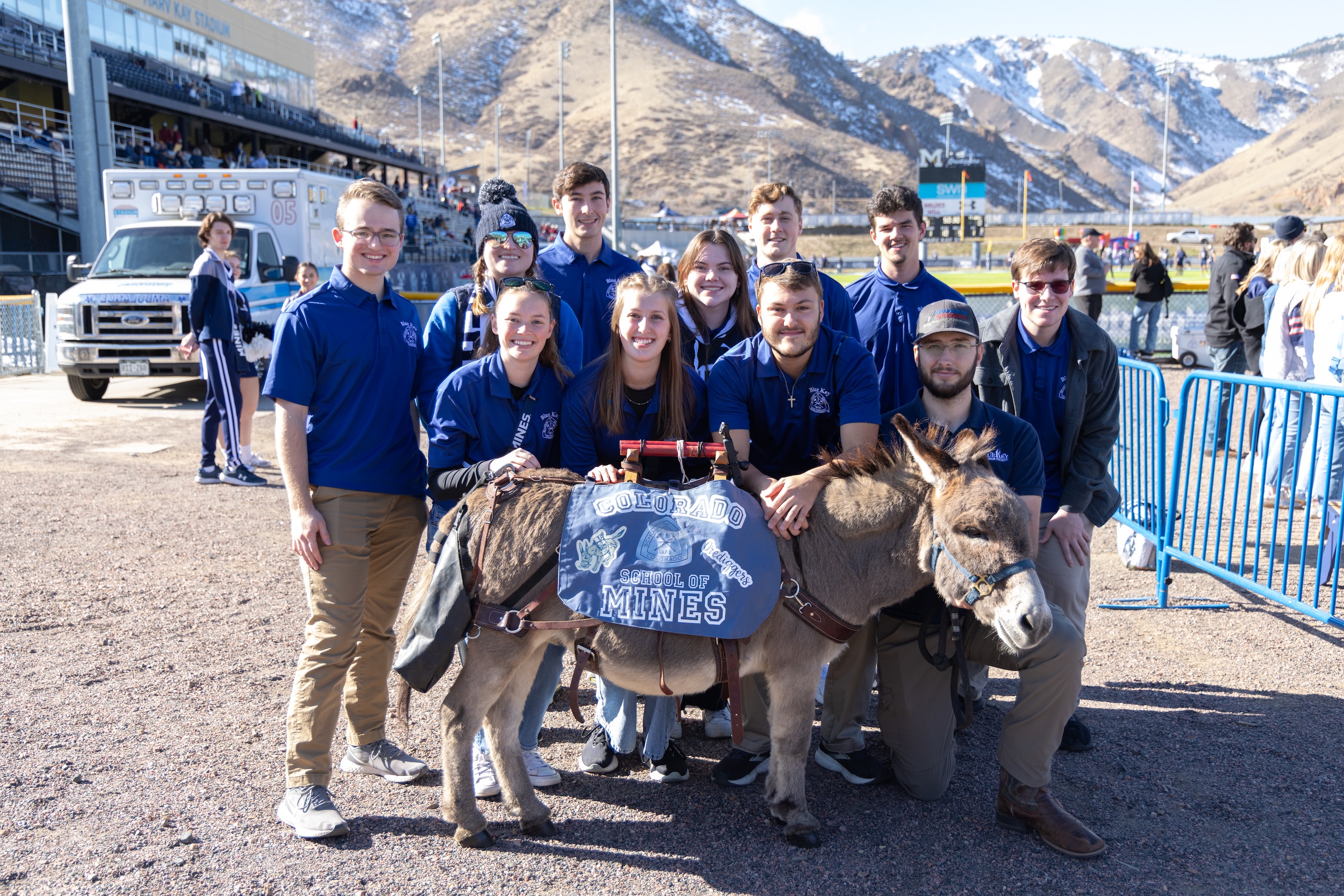 A group of Mines student stand behind Blaster the Burro.