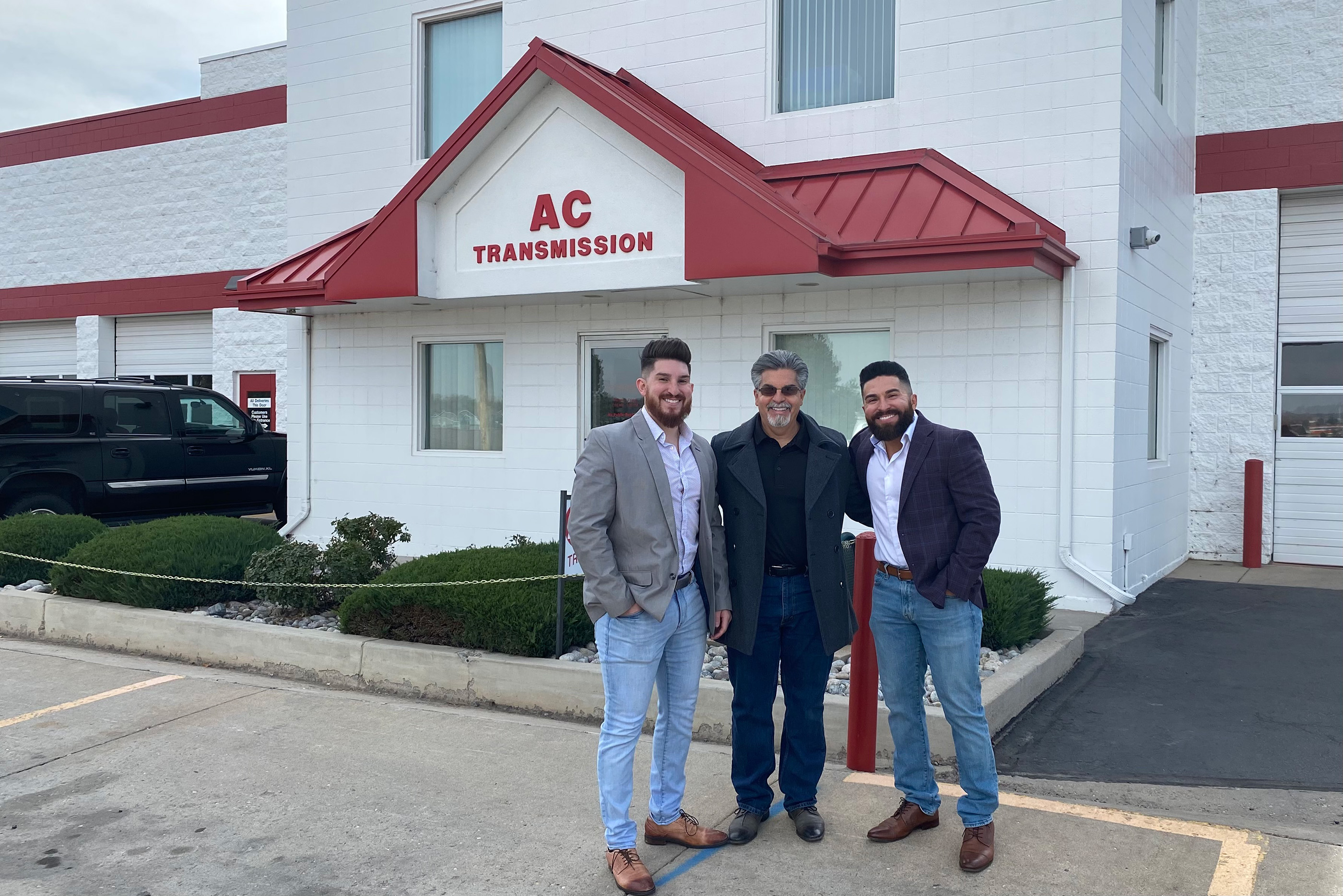 Chris and Derek Saykally stand with their dad outside of AC Transmission