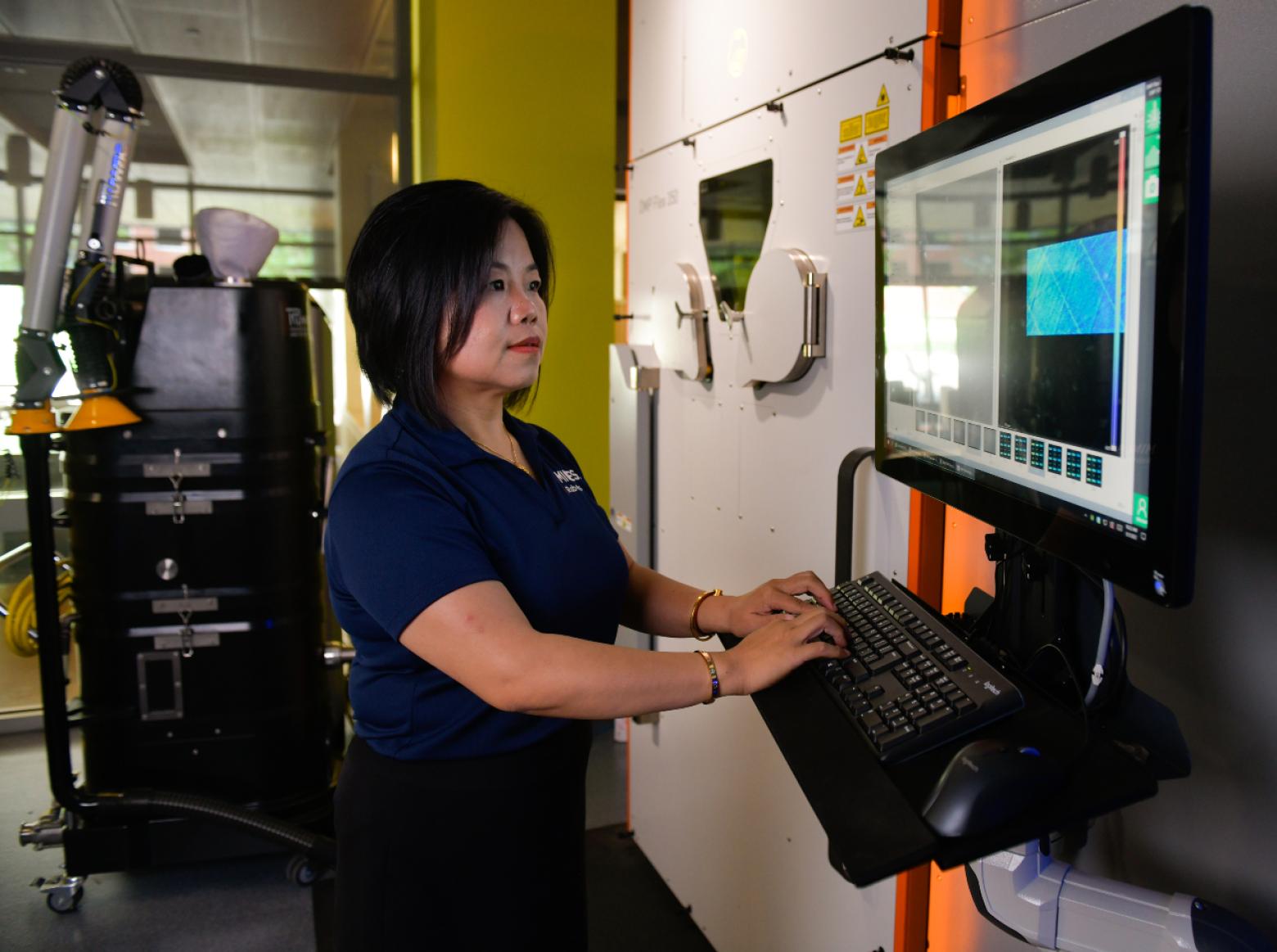 Xiaoli Zhang working on a computer