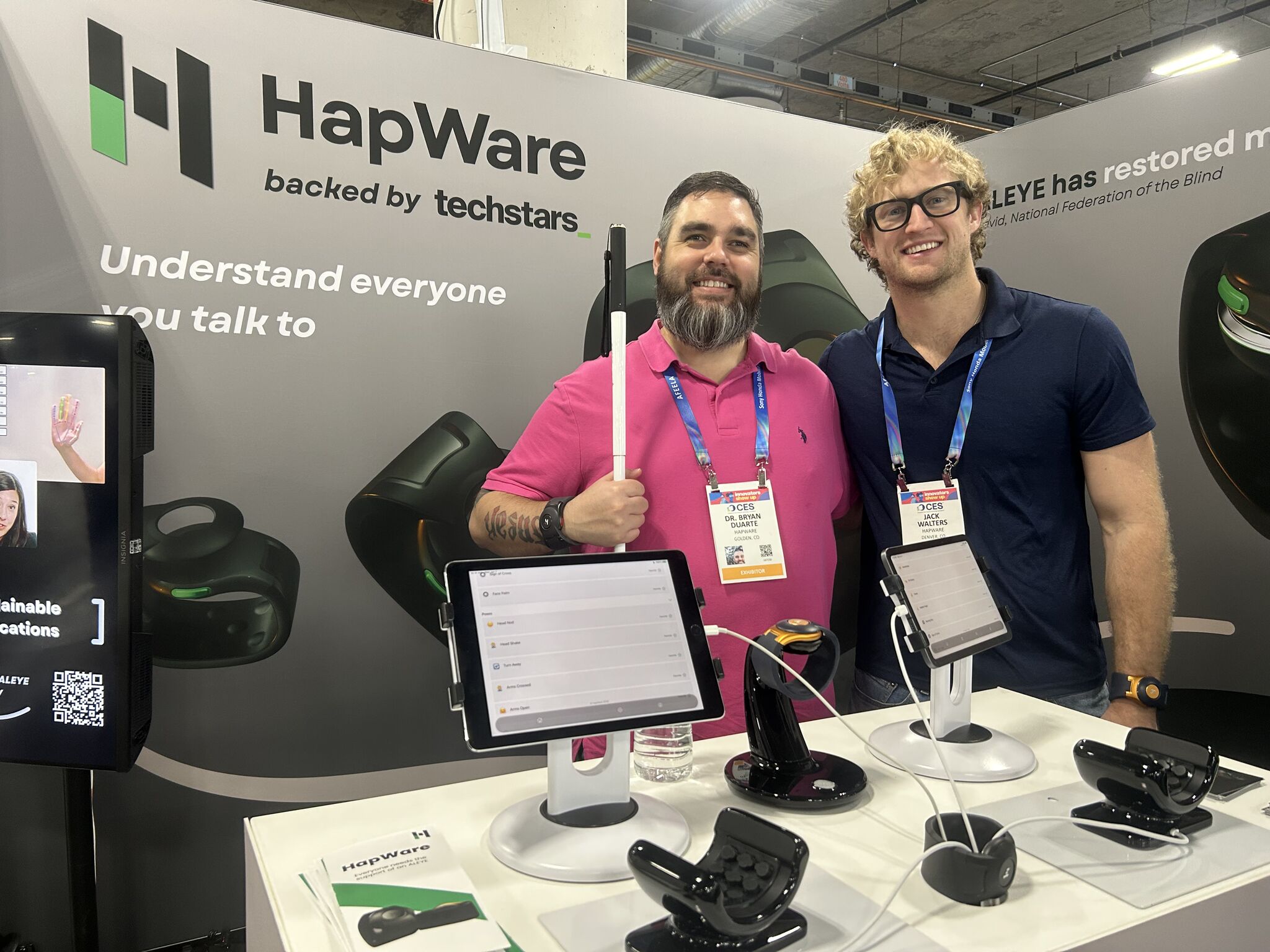 Hapware founders displaying their technology at a booth